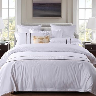 Luxury 100% cotton hotel bedding set on a modern hotel bed in white