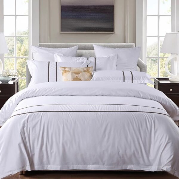 Luxury 100% cotton hotel bedding set on a modern hotel bed in white
