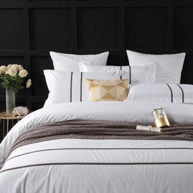 Luxury 100% cotton hotel bedding set on a modern hotel bed in white