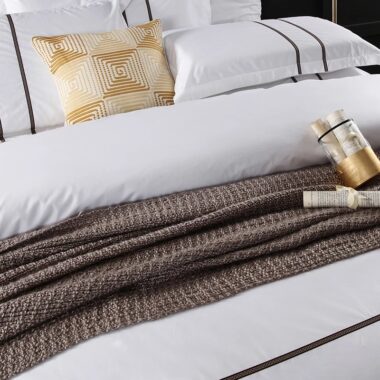 Luxury 100% cotton hotel bedding set on a modern hotel bed in white
