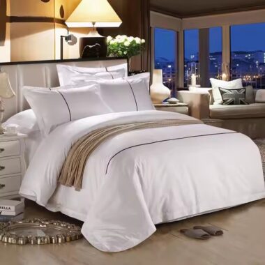 Luxury 100% cotton hotel bedding set on a modern hotel bed in white
