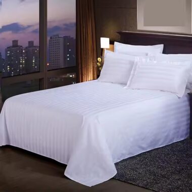 White premium down duvet bedding set arranged in luxury hotel guestroom