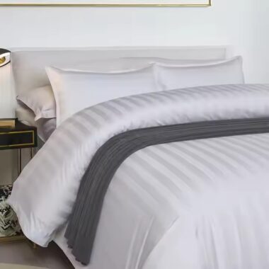White premium down duvet bedding set arranged in luxury hotel guestroom