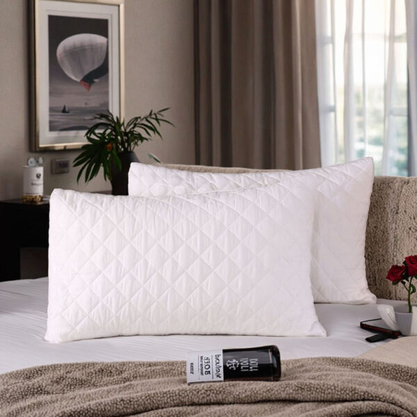 Soft white hotel pillow and pillowcase for hospitality rooms
