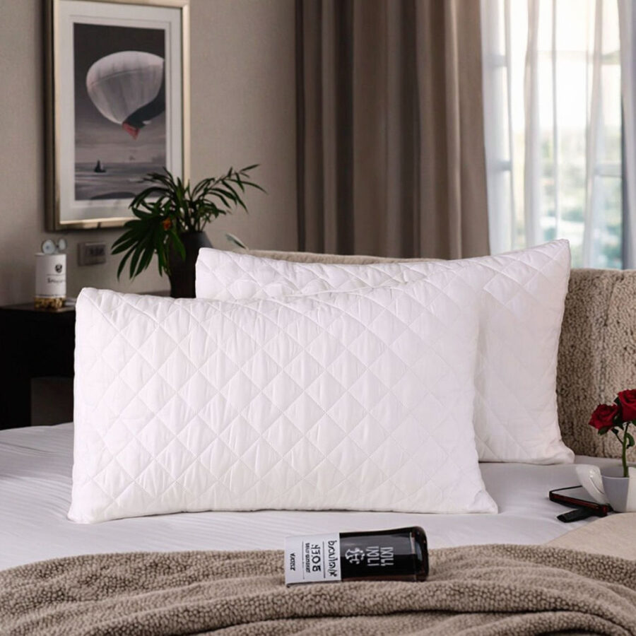 Soft white hotel pillow and pillowcase for hospitality rooms