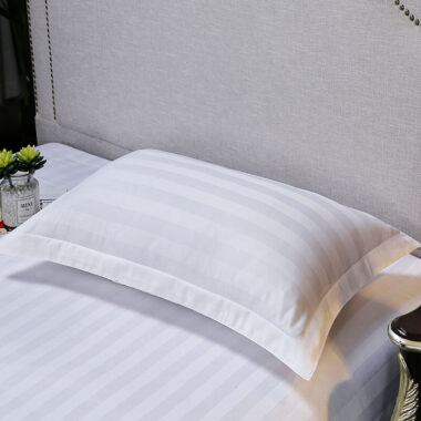 Soft white hotel pillow and pillowcase set for hospitality rooms