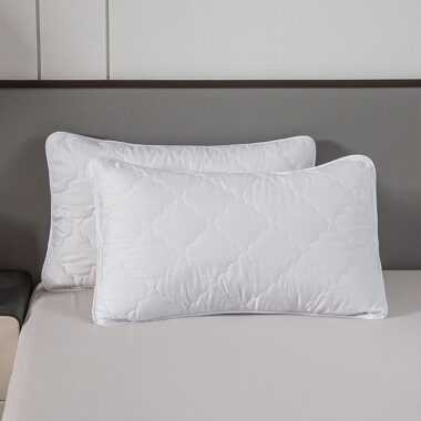 Soft white hotel pillow and pillowcase for hospitality rooms