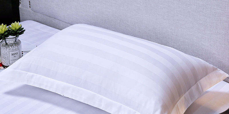 Soft white hotel pillow and pillowcase set for hospitality rooms