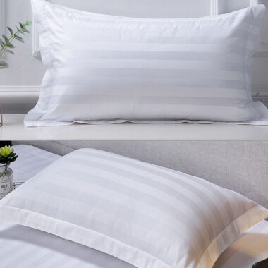Soft white hotel pillow and pillowcase set for hospitality rooms