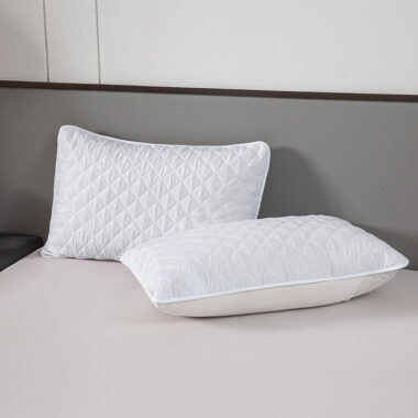 Soft white hotel pillow and pillowcase for hospitality rooms